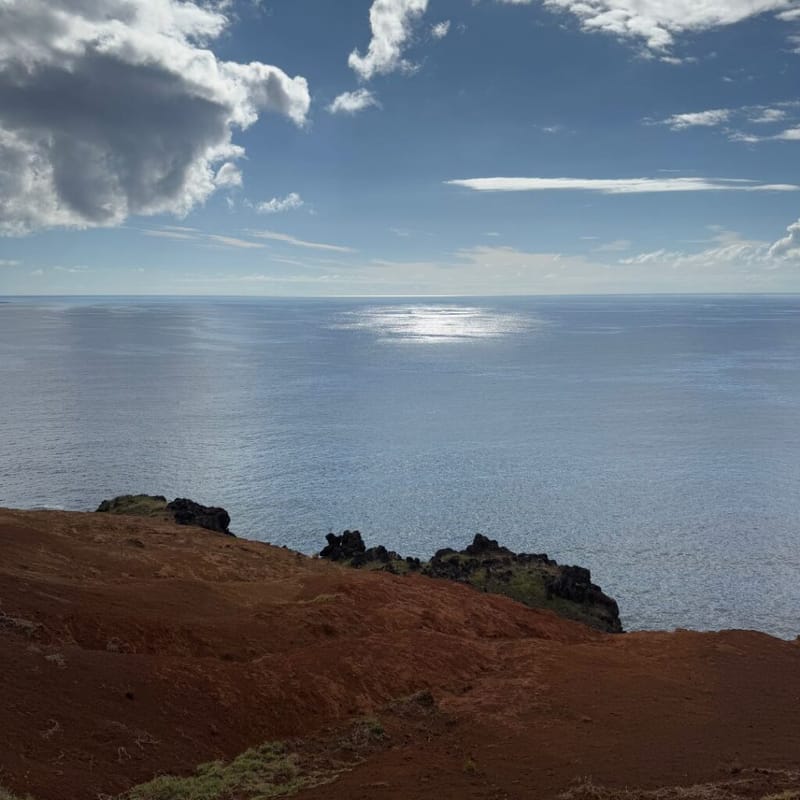 Red volcanic coastline of Easter Island overlooking the Pacific Ocean