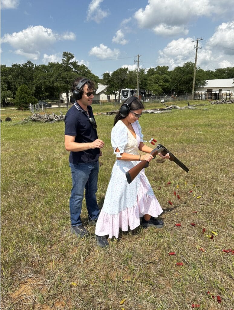 John Arrow and a companion wearing ear protection at a shooting range on a Texas ranch